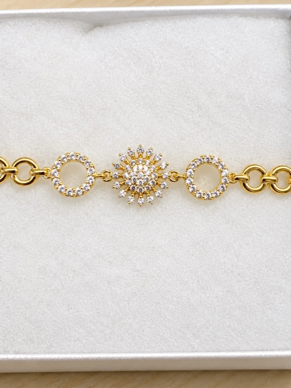 Gold open circle bracelet with CZ flower and circle pave accents